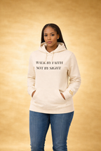 Cream unisex hoodie by CIM Designs featuring "Walk By Faith" text, casual fit, and soft fabric for comfortable everyday wear.